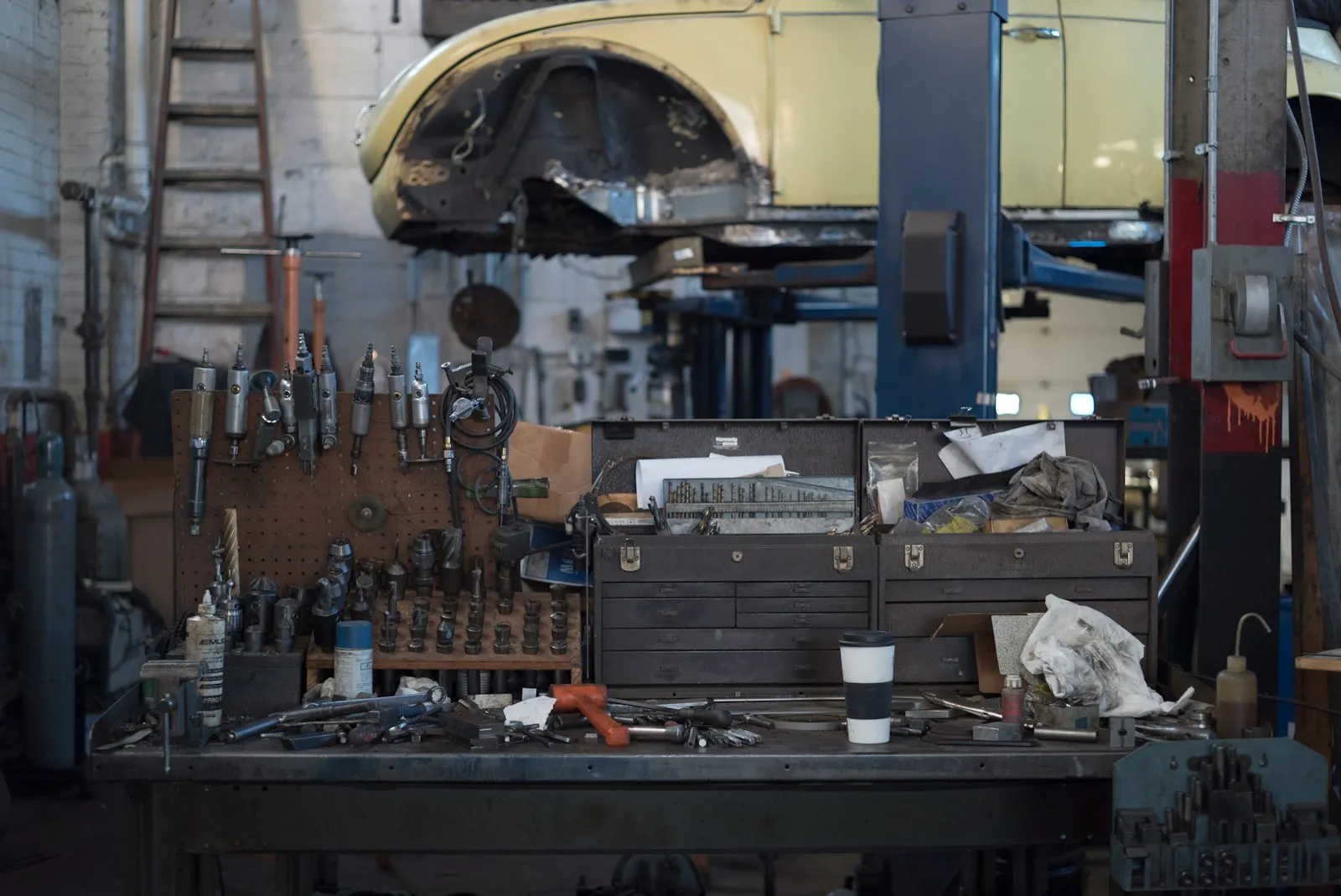 A workbench lined with wrenches, sockets and tool drawers