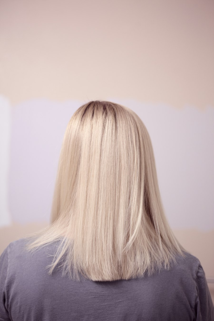 Long straight bright blonde hair, seen from behind
